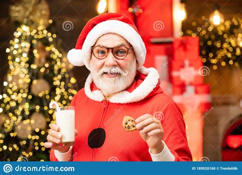 Thanksgiving Day And Christmas Happy Santa Claus Eating A Cookie And