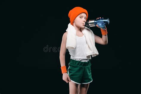 Sporty Boy Drinking Water From Bottle And Looking At Camera Stock Photo