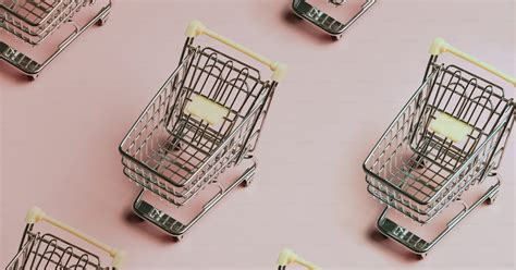 A Group Of Shopping Carts Sitting On Top Of A Pink Surface Photo