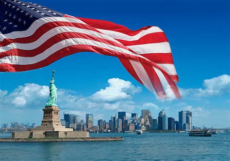 The Statue Of Liberty And The American Flag Stock Photos Pictures