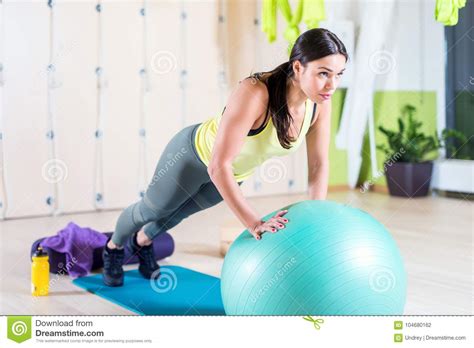 Fit Woman Doing Push Ups With Medicine Ball Workout Out Arms Exercise