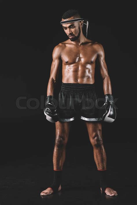 Serious Muay Thai Fighter With Mongkhon On Head Isolated On Black