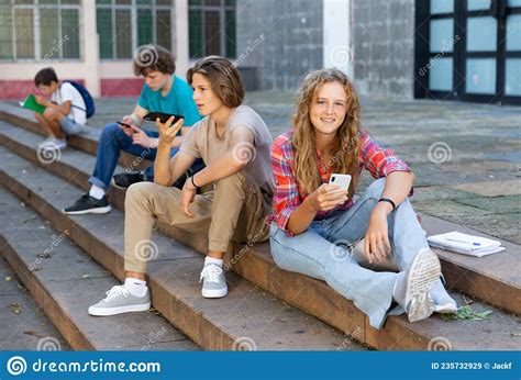 Teenagers With Smartphones Sitting On Stairs Stock Image Image Of