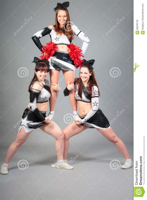 Cheerleader Team Performing A Thigh Stand Stock Image Image Of Sports