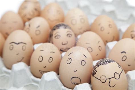 Various Facial Expressions Painted On Brown Eggs In Egg Carton Stock