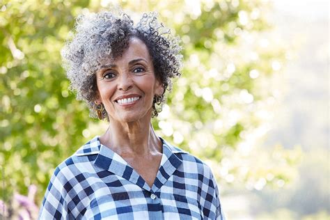 Closeup Portrait Of African American Senior Woman In Nature By