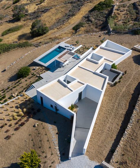 react architects embeds the nest house into the greek island of paros