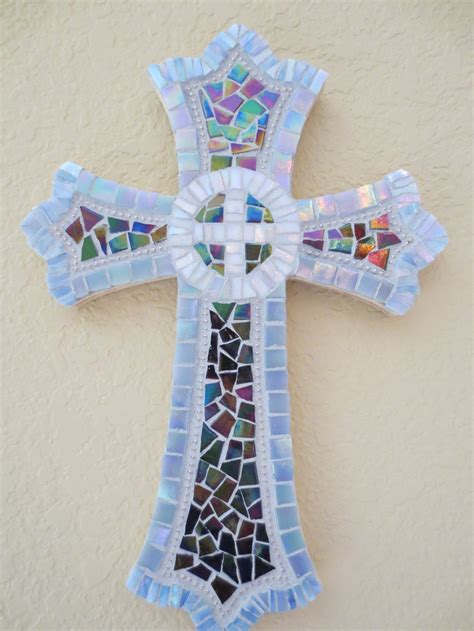 A Cross Made Out Of Mosaic Glass Sitting On Top Of A Wall