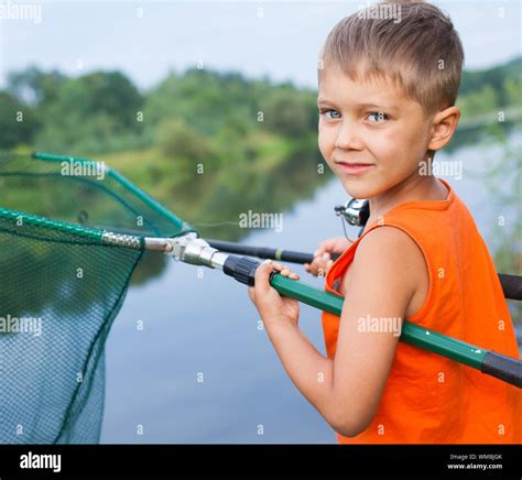 Summer Vacation Photo Of Little Boy Fishing On The River Stock Photo