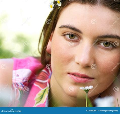 Portrait Of A Young Caucasian Woman Outdoors With Flower Stock Image