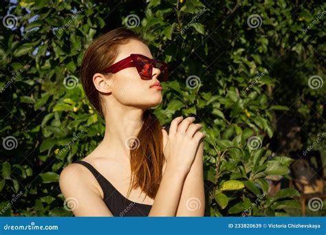 Attractive Woman Posing On The Background Of Green Leaves Nature Stock