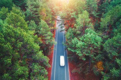 Aerial View Of Road With Blurred Car In Green Forest Stock Image