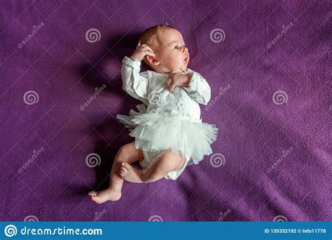 Soft Portrait Of Peaceful Sweet Newborn Infant Baby Lying On Bed While
