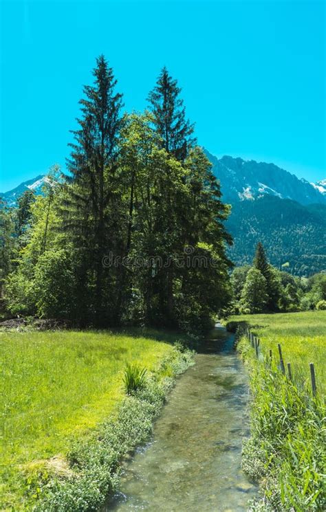 River Flowing Through The Trees And Meadows In Bavaria Germany Stock