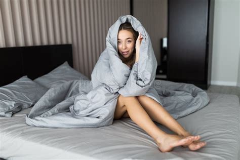 Smiling Woman Under A Duvet In Her Bedroom Closeup Portrait Of A
