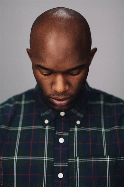 Portrait Of Young African Man Looking Down By Stocksy Contributor