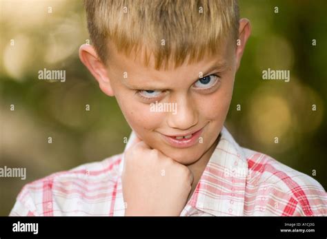 Nine Year Old Boy With A Mischievous Look On His Face Stock Photo Alamy