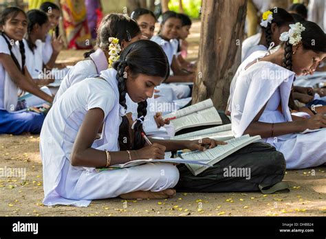 Rural Indian Village High School Girls Writing In Books In An Outside