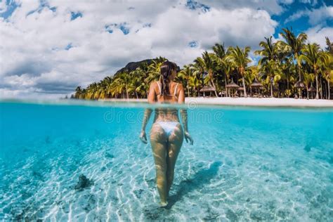 Woman Swimming Underwater In Transparent Blue Ocean At Mauritius Le