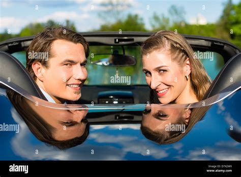 Young Hip Couple Man And Woman With Cabriolet Convertible Car In