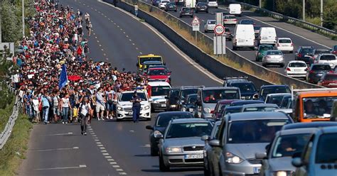 Thousands Of Refugees Begin Walking Along Motorway To Austria After