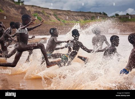 Young Boys Run Into The Omo River Ethiopia Stock Photo Alamy