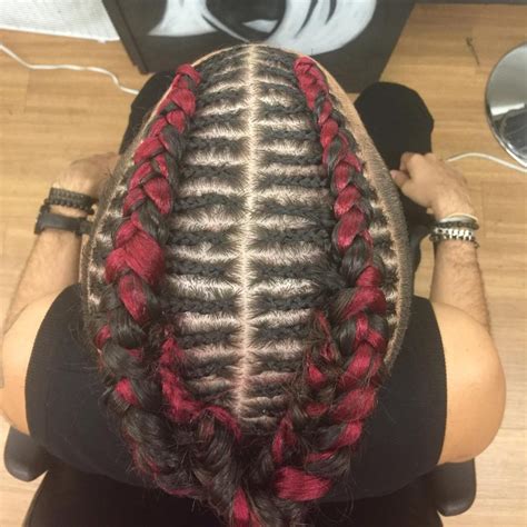 Braids woven into circular patterns create a stunning hairstyle for the guy that is cute bun displaying red and black hue, made with braids knotted in cornrows hairstyle, looks cool. Cornrow Braid Hairstyles: 40 Best Braided Hairstyles For ...