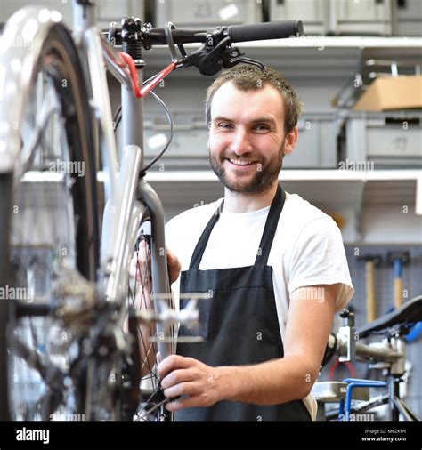 Portrait Of A Friendly And Competent Bicycle Mechanic In A Workshop