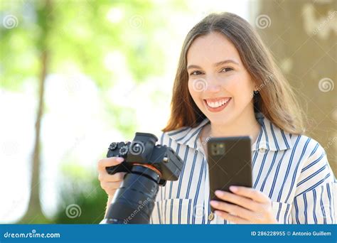 Happy Photographer Holds Camera And Phone Posing Stock Image Image Of