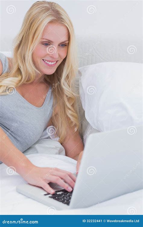 Woman Typing On Her Laptop On Her Bed Stock Image Image Of Calm Pillows 32232441
