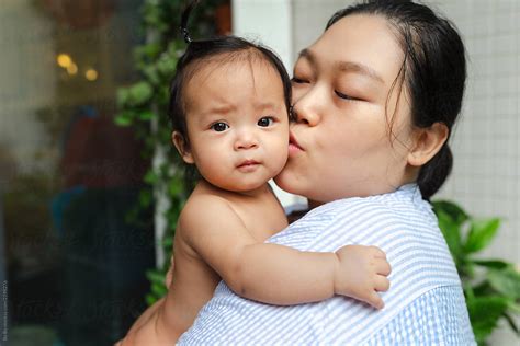 Asian Mother With Her Baby Girl In Home By Stocksy Contributor Bo Bo