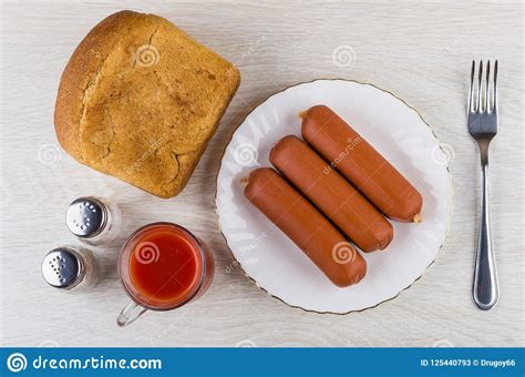 Tomato Juice Salt Pepper Bread Sausages In Plate Fork Stock Image