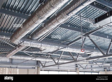 Hvac Ventilation Pipes In Silver Insulation Material Hanging From The