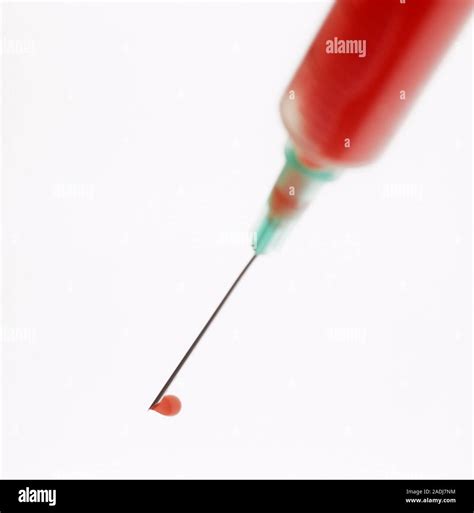 Blood Sample Blood Filled Syringe And Needle With A Drop Of Blood The