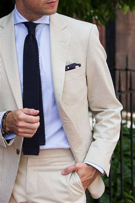 Pairing this ensemble with tobacco suede tassel loafers can give you relaxed approach. Cream seersucker suit with dark blue knit tie #tie # ...