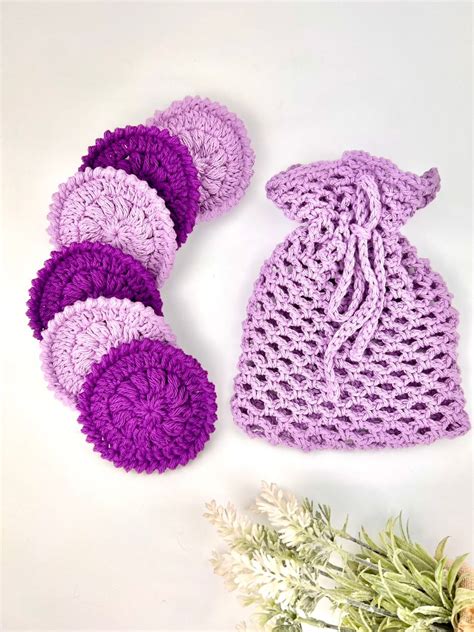 A Set Of Round Crochet Face Scrubbies And A Mesh Bag Made With Purple