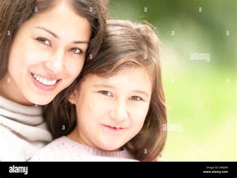 Beautiful And Happy Young Mother With Her Small Daughter Outdoors Both Woman And Small Girl