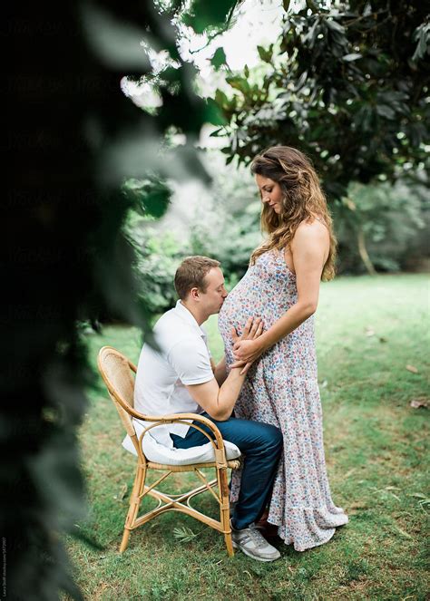Maternity Session With Man Kissing Wifes Pregnant Belly Del