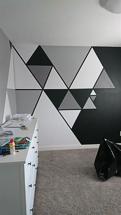 A Black And White Geometric Wall In A Bedroom