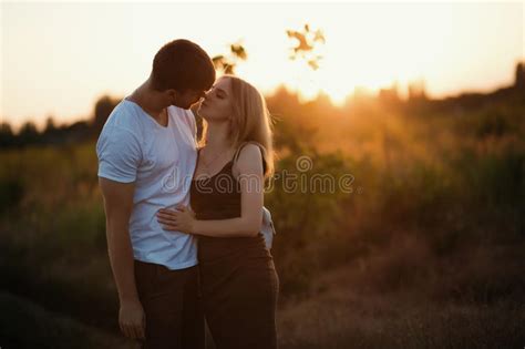 Romantic Couple At Sunset Two People In Love At Sunset Or Sunrise Man And Woman On Field Stock