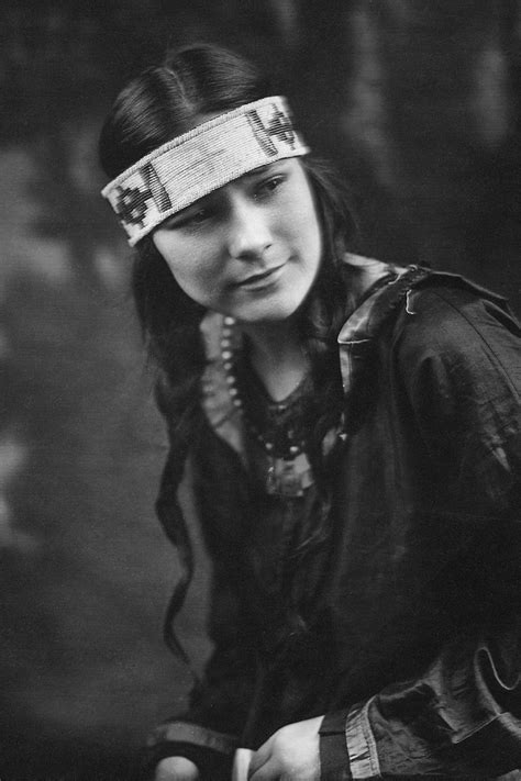 An Old Photograph Of A Native American Girl In Traditional Dress B