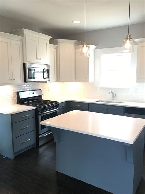 White Quartz Kitchen Cabinets Paired With White Upper Cabinets And Blue