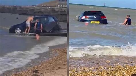 moment driver desperately tries to save car swept out to sea on uk beach youtube