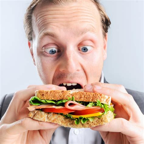 Comical Man Eating Sandwich With Funny Expression Stock Photo Image