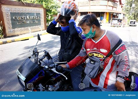 Riders Of A Motorcycle Taxi And Delivery Service Company Check Their