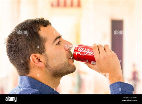Attractive Young Man Drinking A Coca Cola Can Stock Photo Alamy