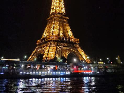 The Brightly Illuminated Eiffel Tower At Night Paris France Go To