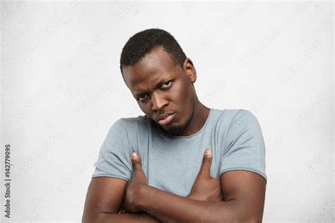 Grumpy And Dissatisfied Young African American Man Wearing Casual Grey