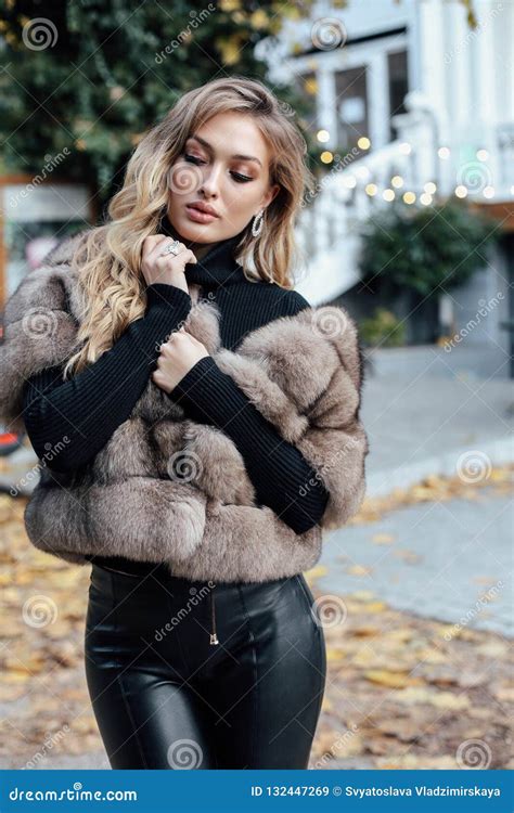 beautiful woman with blond hair in luxurious fur coat walking on stock image image of autumn