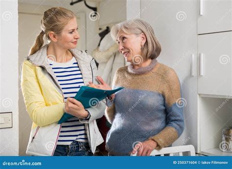 Mature Woman Answers Questions Of Interviewer At Home Stock Photo